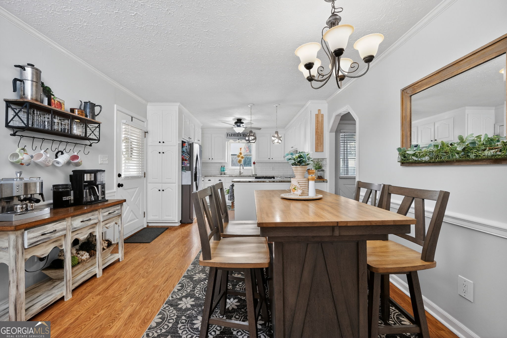119 Old Town Road Gray, GA 31032 - Photo 10 of 39 a view of a dining room with furniture a chandelier and wooden floor