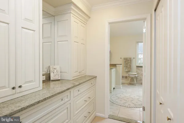 a bathroom with a granite countertop toilet sink and mirror