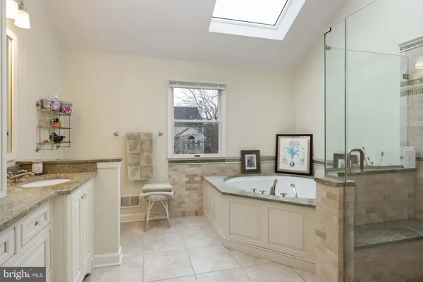 a bathroom with a bathtub and a shower