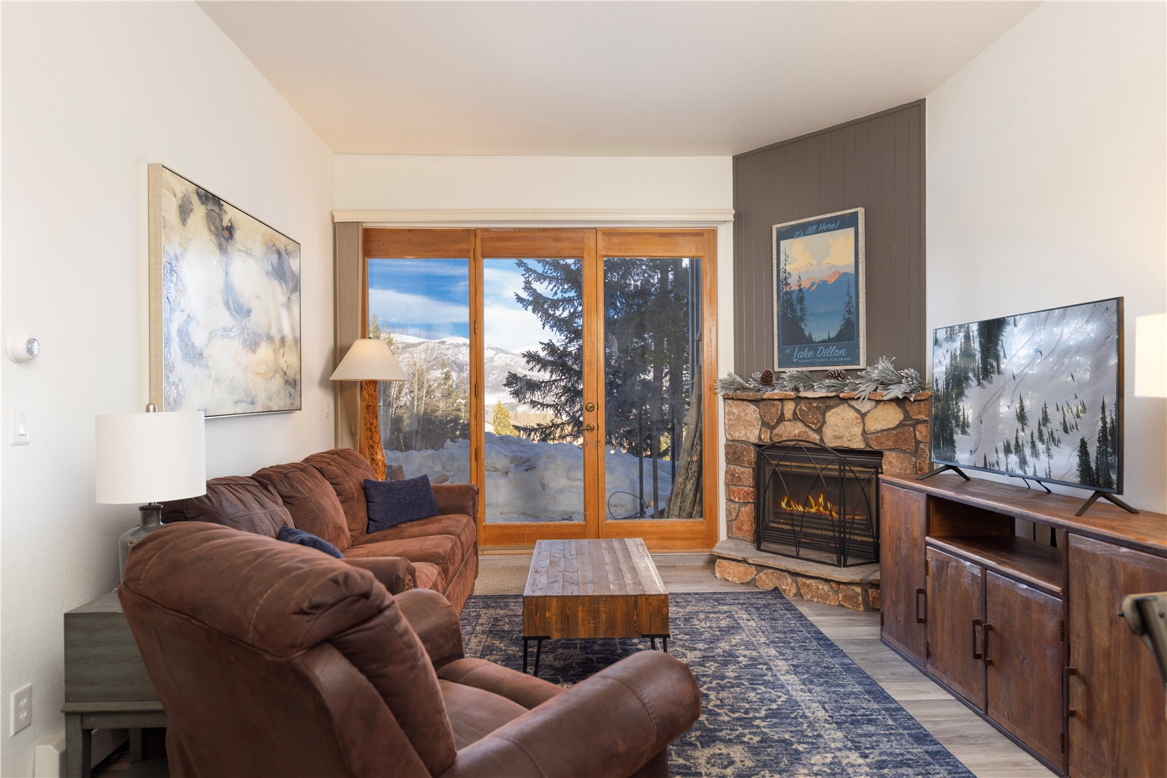 89410 Ryan Gulch Road, Unit 104 Silverthorne, CO 80498 - Photo 3 of 31 a living room with furniture and a fireplace
