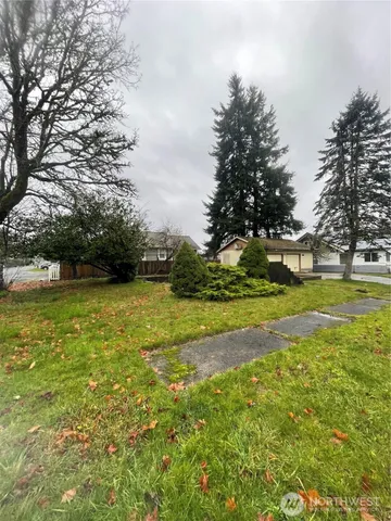 a view of yard with swimming pool and green space
