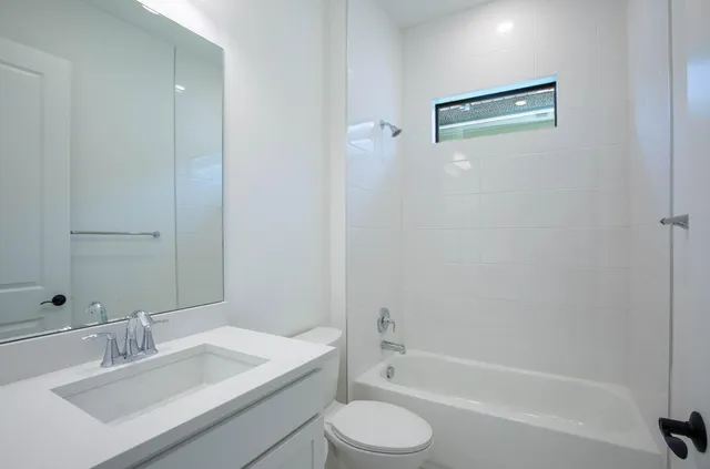 a kitchen with stainless steel appliances granite countertop a sink and a refrigerator