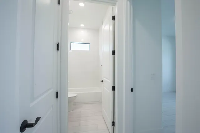 a living room with furniture and a pool table