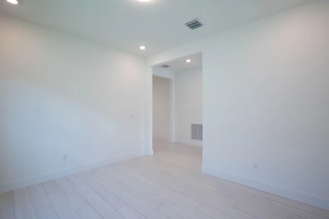 an aerial view of a house with a garden and lake view