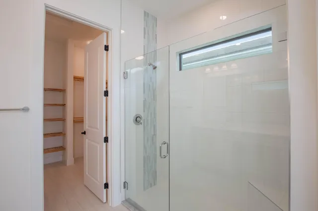 a view of kitchen with kitchen island stainless steel appliances refrigerator cabinets and a sink