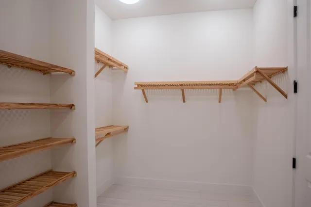 an empty room with a empty space and windows