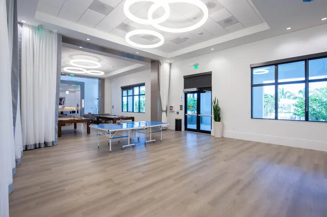 a view of a house with a big yard and potted plants