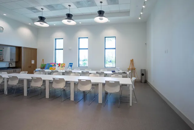 a living room with furniture a rug and a chandelier
