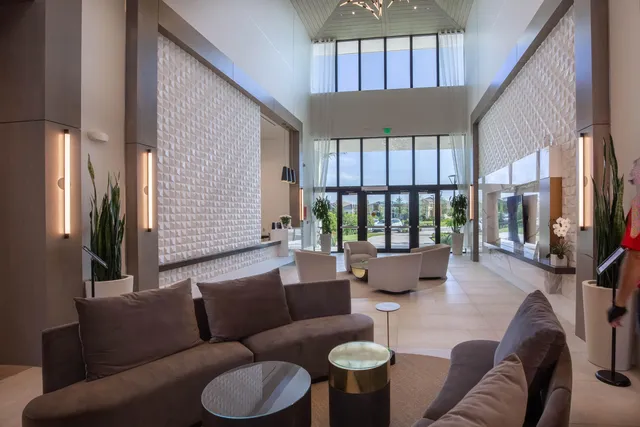 a view of swimming pool with outdoor seating and house in the background