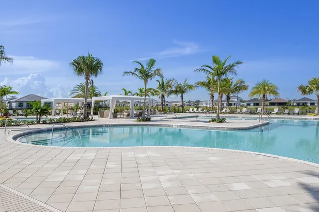 a kitchen with stainless steel appliances granite countertop a sink and a refrigerator