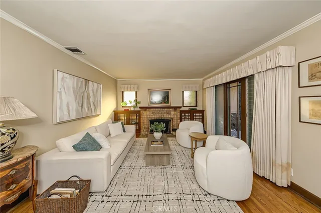 a living room with furniture a table and kitchen view