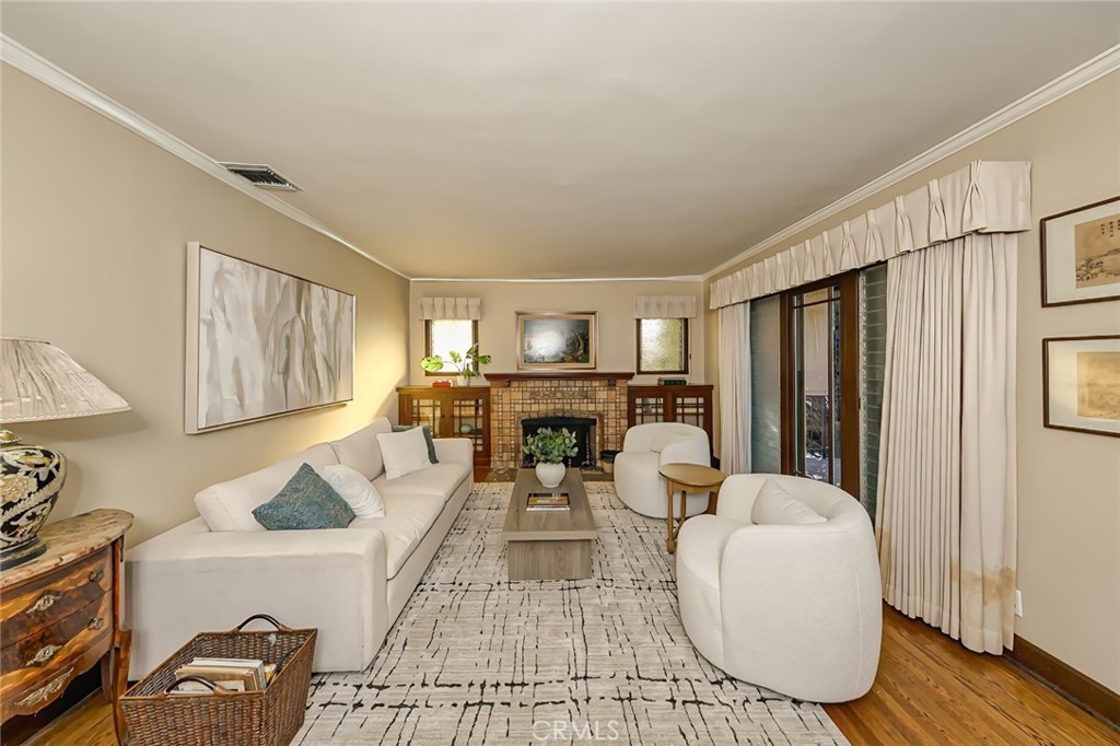 a living room with furniture a table and kitchen view