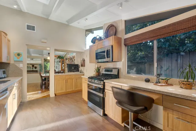 a kitchen with a stove a sink and a refrigerator