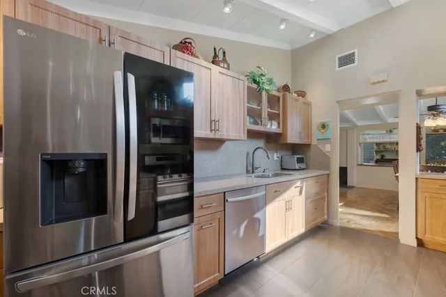 a kitchen with stainless steel appliances a refrigerator and a sink