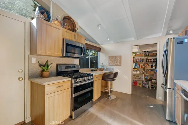 a kitchen with stainless steel appliances granite countertop a stove and a refrigerator