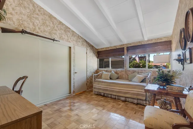 a bedroom with furniture and a potted plant