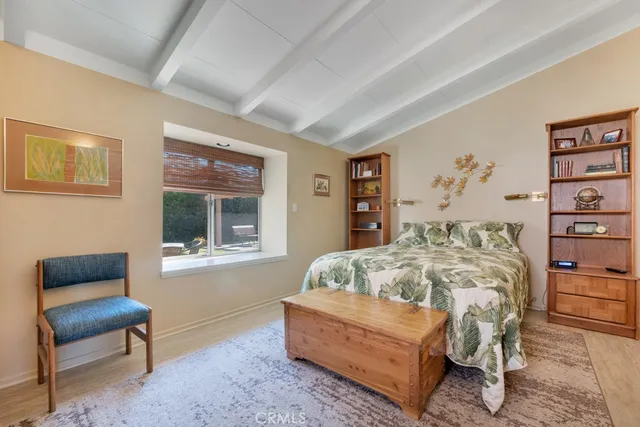 a bedroom with furniture and a wooden floor