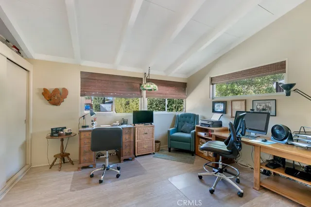 a view of a livingroom with workspace and a couch