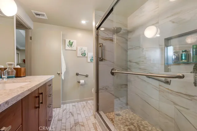 a bathroom with a granite countertop sink toilet and a mirror