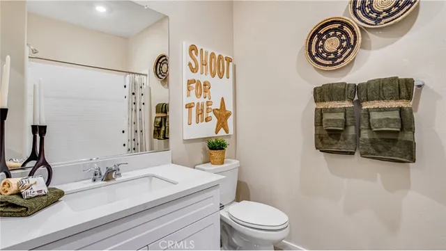 a bedroom with a large bed and a potted plant
