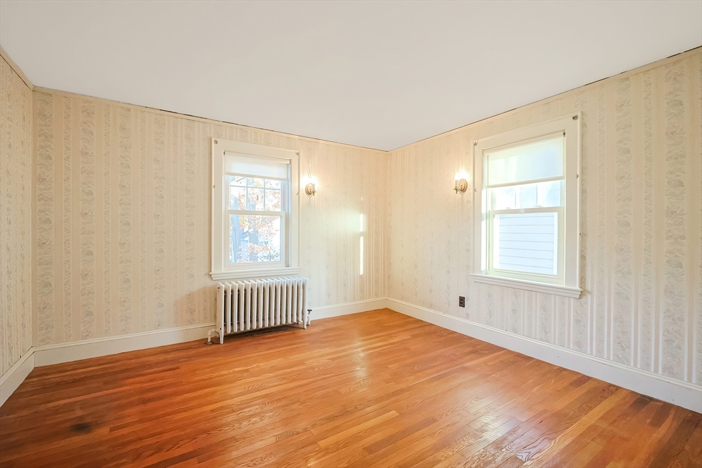 249 Russett Road Brookline, MA 02467 - Photo 20 of 42 an empty room with wooden floor and windows