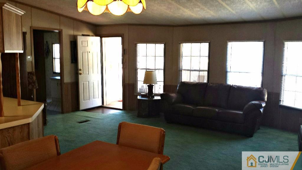15 Longfellow Road, Unit 15 North Brunswick, NJ 08902 - Photo 3 of 12 a living room with furniture and a large window