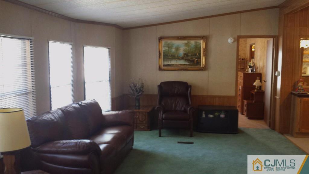 15 Longfellow Road, Unit 15 North Brunswick, NJ 08902 - Photo 4 of 12 a living room with furniture and a gate