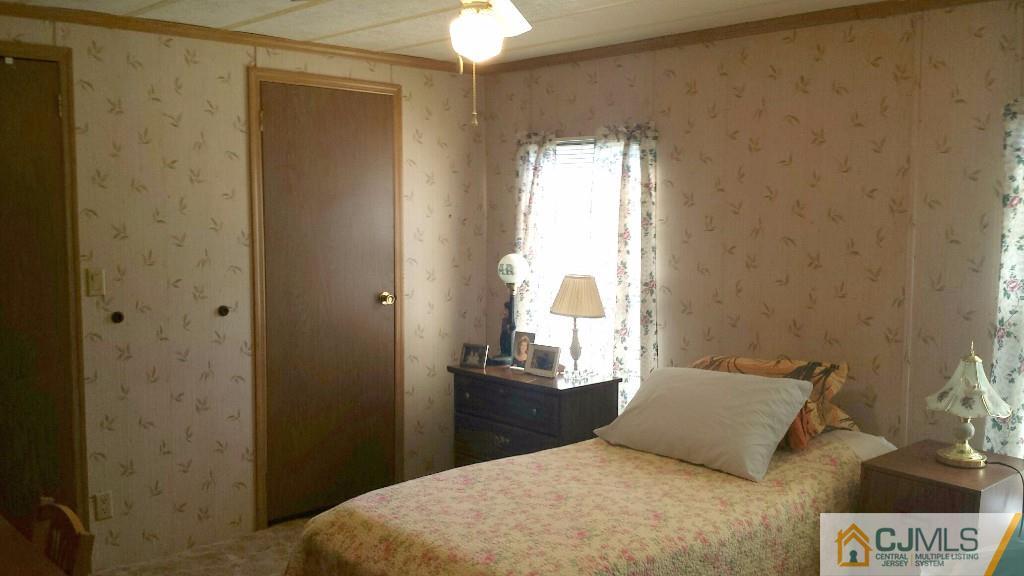15 Longfellow Road, Unit 15 North Brunswick, NJ 08902 - Photo 8 of 12 a bedroom with a bed and a window