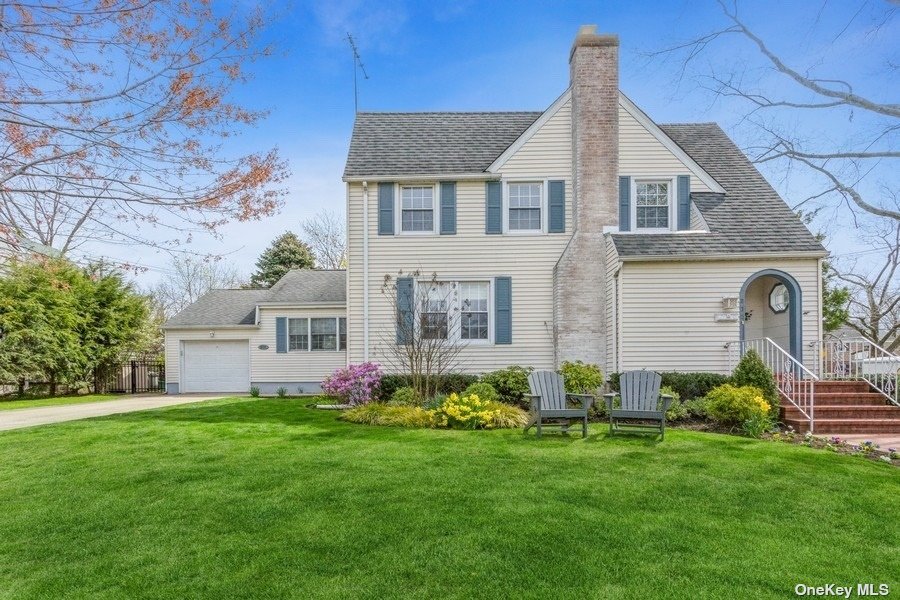 a front view of house with yard and green space