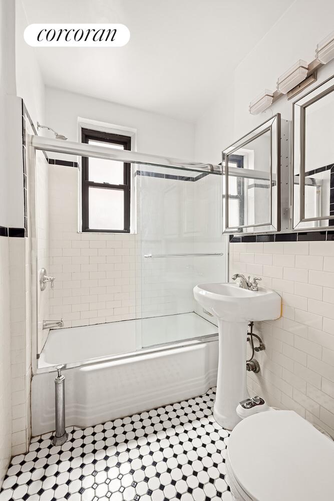 350 East 54th Street, Unit 3H Manhattan, NY 10022 - Photo 4 of 5 a bathroom with a sink a toilet and shower