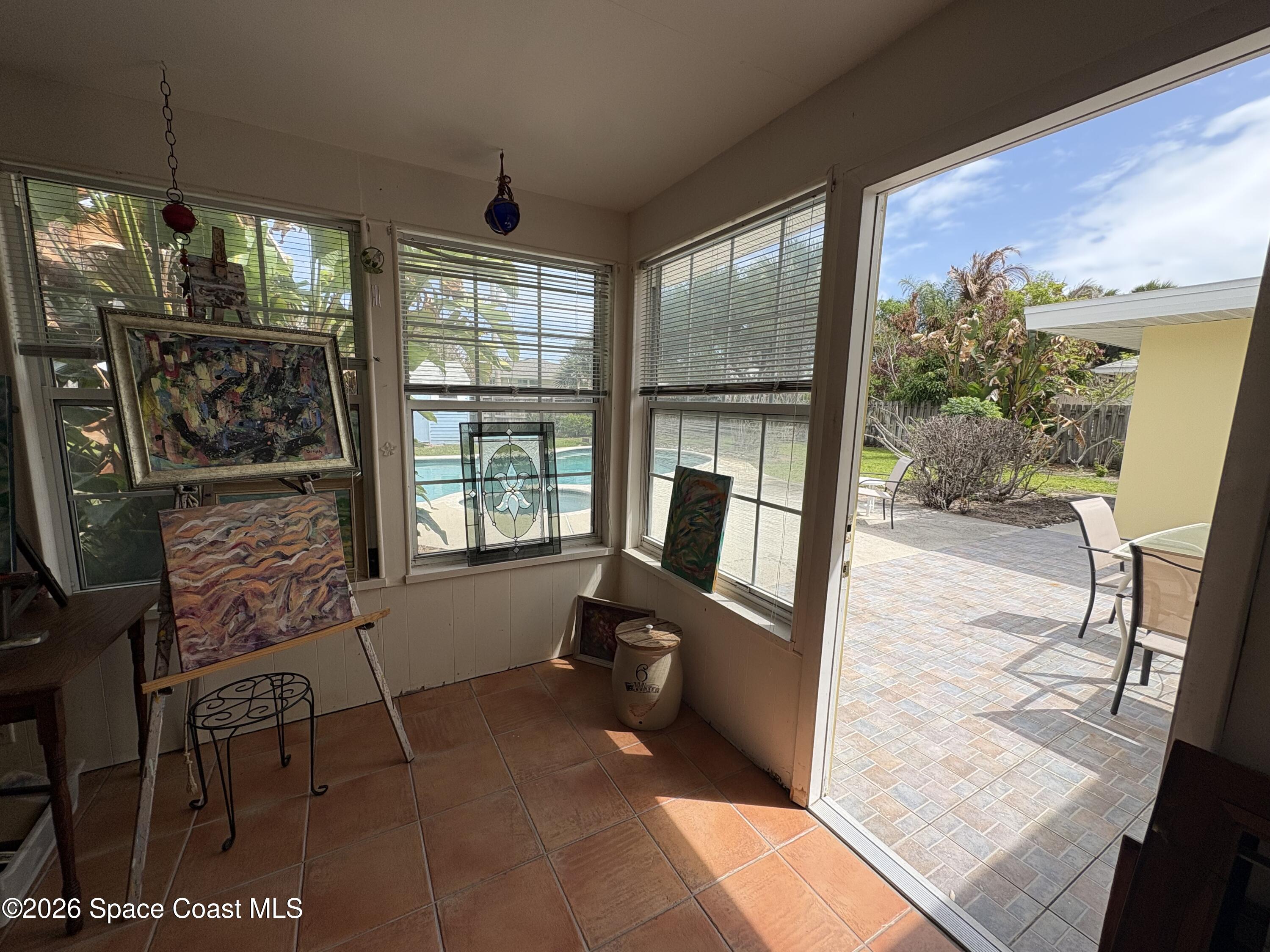 212 Surf Road Melbourne Beach, FL 32951 - Photo 6 of 14 a living room with furniture and a floor to ceiling window