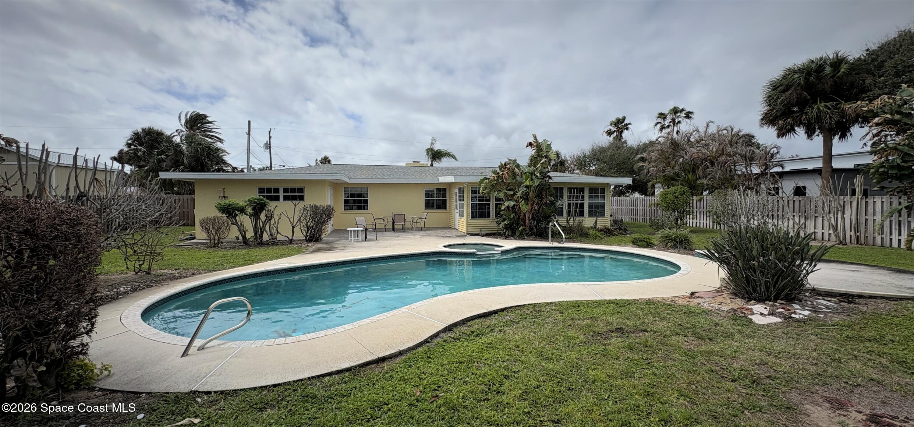 212 Surf Road Melbourne Beach, FL 32951 - Photo 9 of 14 an aerial view of a house with swimming pool and garden