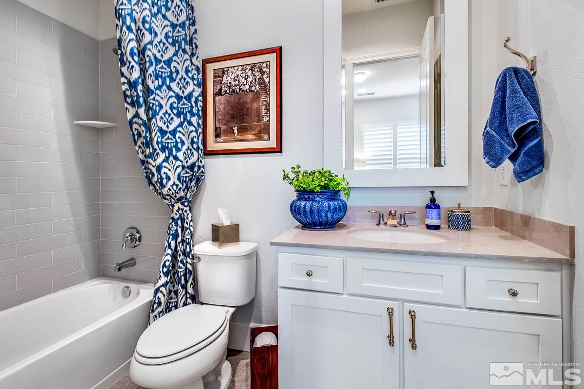 2906 Miramis Court Reno, NV 89521 - Photo 19 of 25 a bathroom with a toilet sink vanity tub and shower