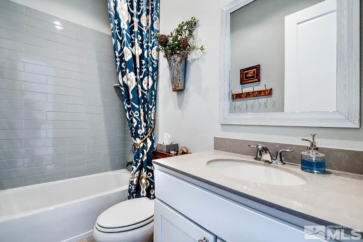 2906 Miramis Court Reno, NV 89521 - Photo 23 of 25 a bathroom with a sink a toilet and bathtub
