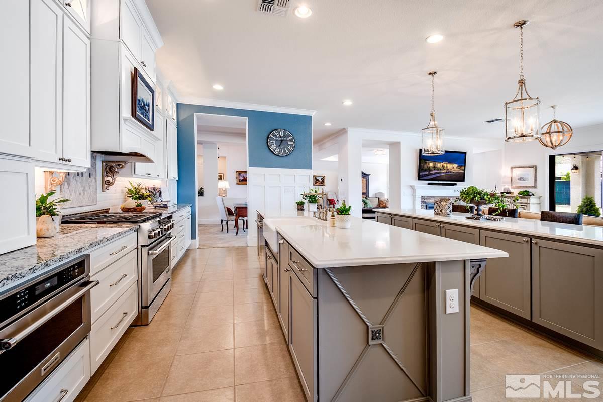 2906 Miramis Court Reno, NV 89521 - Photo 9 of 25 a kitchen with stainless steel appliances granite countertop a sink a stove and a wooden floors