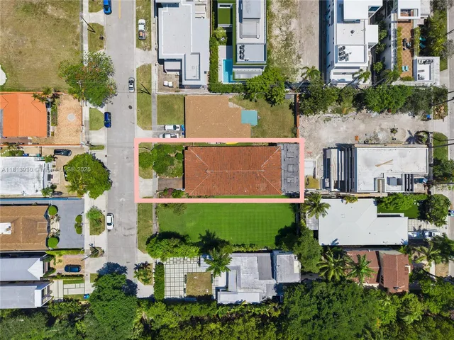 an aerial view of a house with a garden and swimming pool