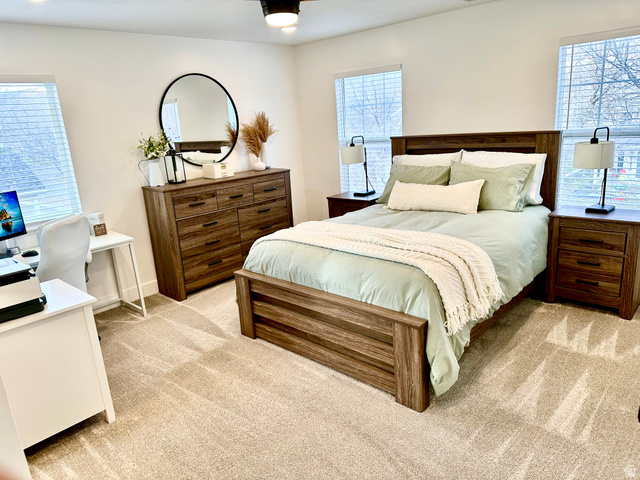 7818 North Windhover Road Eagle Mountain, UT 84005 - Photo 12 of 32 Carpeted room featuring dual windows with blinds, a ceiling fan, and built-in lighting