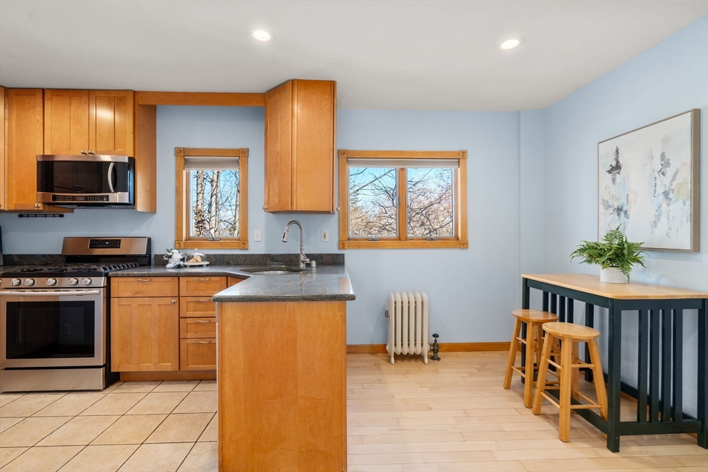 38 Fairfield Street Maynard, MA 01754 - Photo 13 of 42 a kitchen with stainless steel appliances granite countertop a stove a sink and a refrigerator