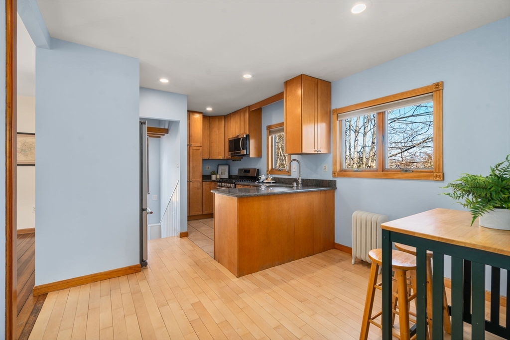 38 Fairfield Street Maynard, MA 01754 - Photo 14 of 42 a kitchen with stainless steel appliances granite countertop a refrigerator and a stove top oven