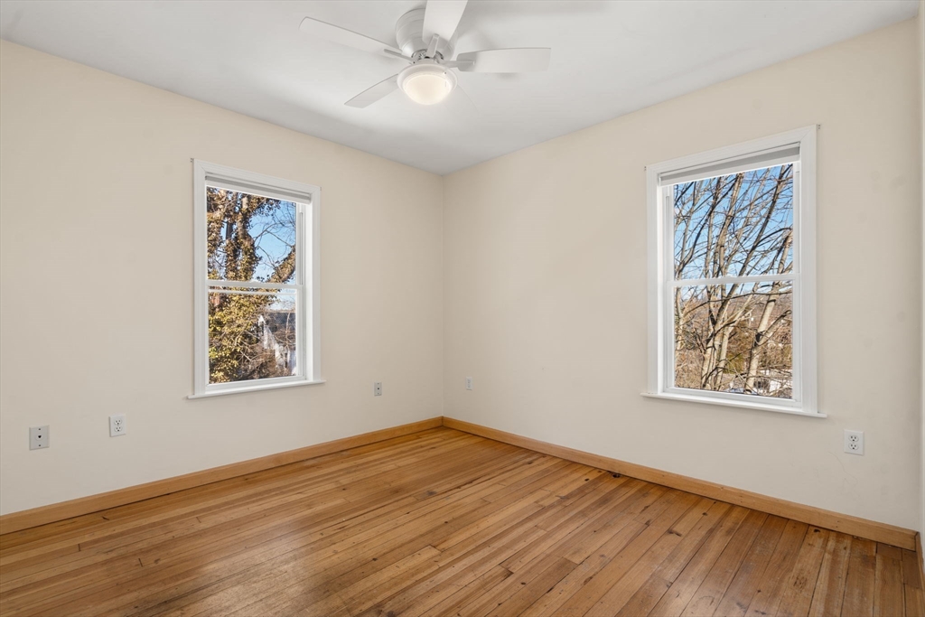 38 Fairfield Street Maynard, MA 01754 - Photo 25 of 42 a view of an empty room with wooden floor and a window