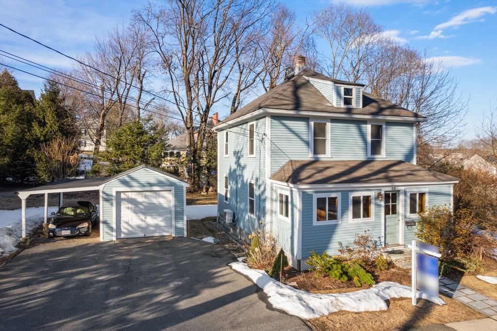 38 Fairfield Street Maynard, MA 01754 - Photo 36 of 42 a front view of a house with a yard garage and outdoor seating