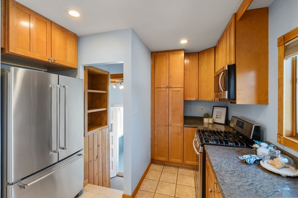 38 Fairfield Street Maynard, MA 01754 - Photo 8 of 42 a kitchen with stainless steel appliances granite countertop a refrigerator and a sink