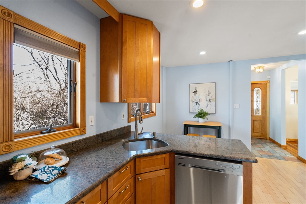 38 Fairfield Street Maynard, MA 01754 - Photo 9 of 42 a kitchen with stainless steel appliances granite countertop a sink a stove and a wooden cabinets