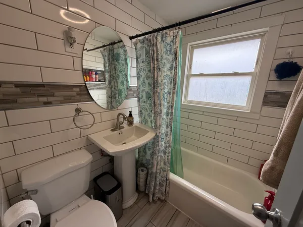 a bathroom with a sink toilet and shower