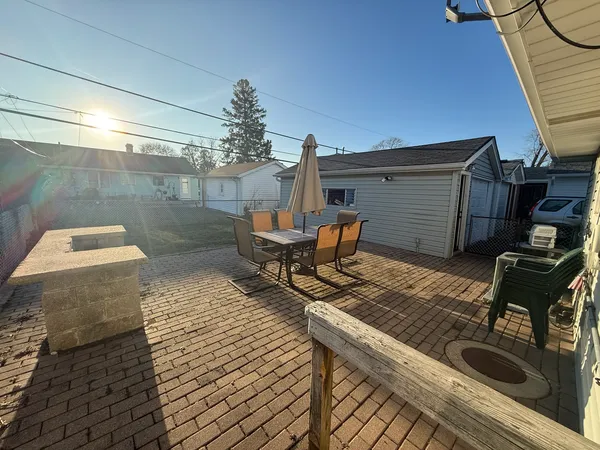 a roof deck with table and chairs