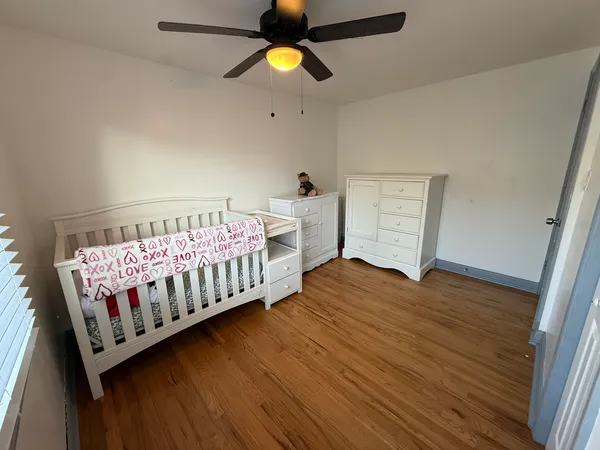 a bedroom with furniture and wooden floor