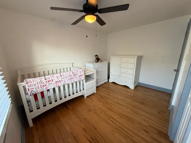 a bedroom with furniture and wooden floor
