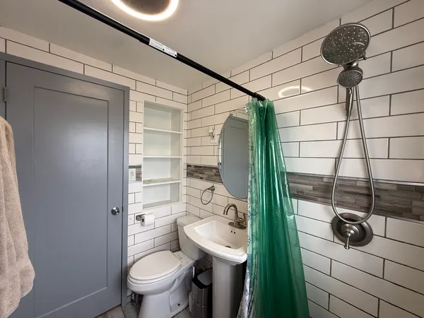 a bathroom with a toilet and a shower
