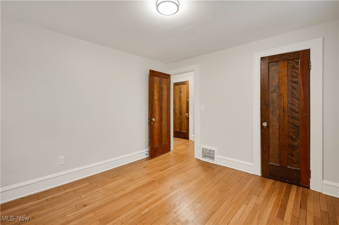 2016 Rossmoor Road Cleveland Heights, OH 44118 - Photo 33 of 46 Unfurnished bedroom with light wood-type flooring and baseboards