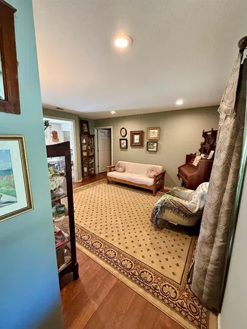 a bedroom with furniture and wooden floor